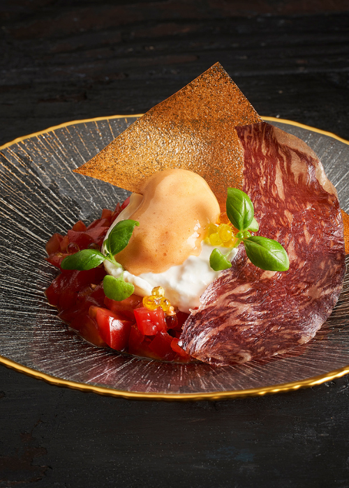 Gedroogde proscuitto met burrata en tomaat